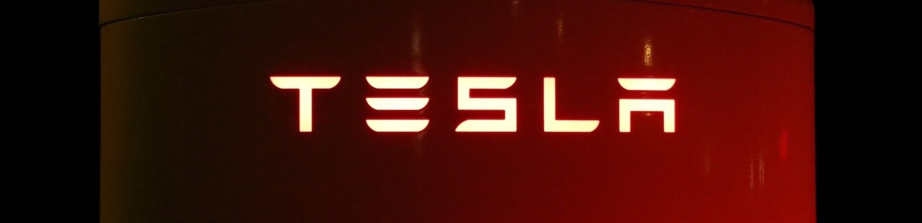 Tesla logo on a red column